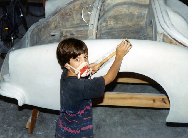 Kaiser Willys owner, Mike Meditz, pictured as a young child and working on his father's 1954 Kaiser Darrin.